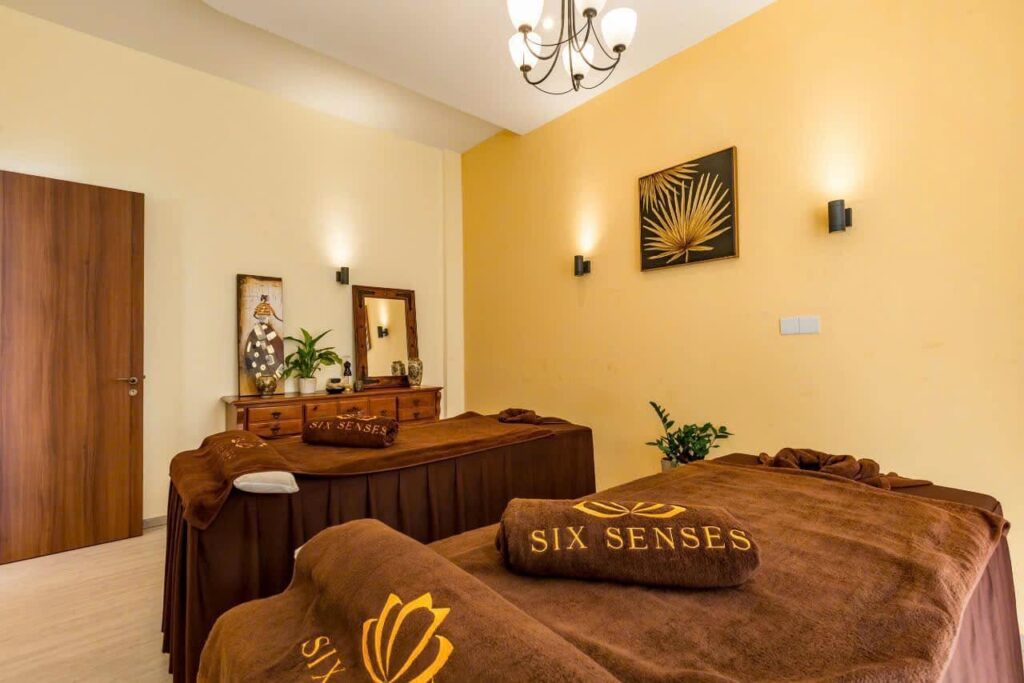Spa treatment room with two massage tables arranged side by side